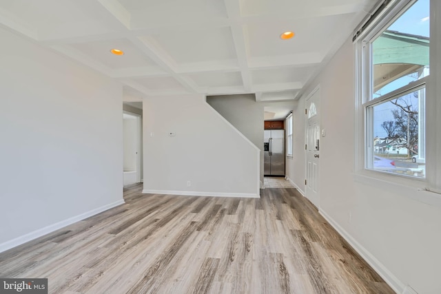 unfurnished living room featuring wood finished floors, baseboards, and coffered ceiling