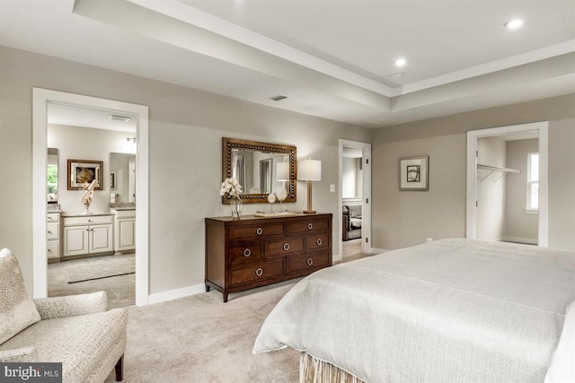 bedroom featuring a tray ceiling, recessed lighting, light colored carpet, visible vents, and baseboards