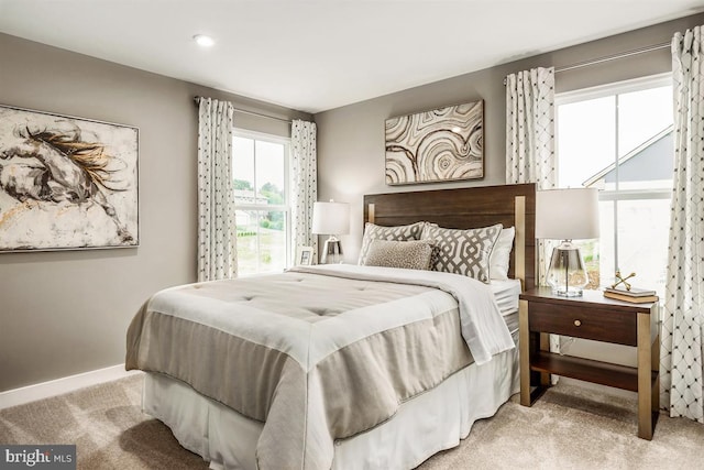 carpeted bedroom featuring baseboards