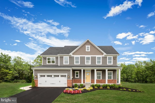 craftsman house featuring a garage, brick siding, and a front lawn