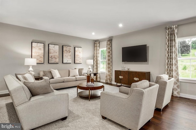 living area featuring recessed lighting, wood finished floors, and baseboards