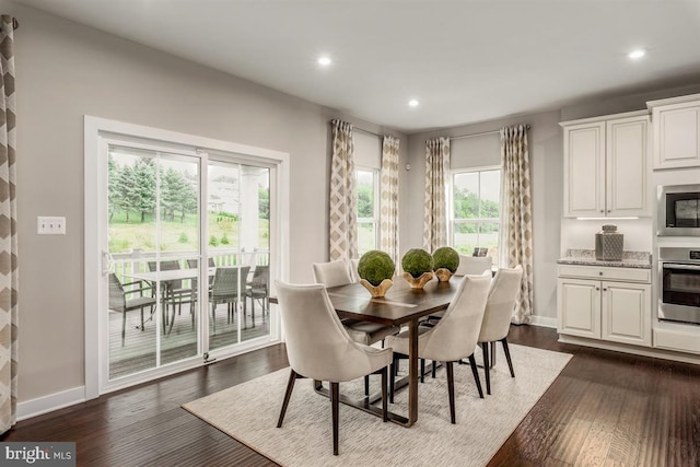 dining area with baseboards, dark wood-style flooring, and recessed lighting