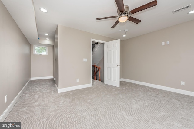 below grade area with ceiling fan, recessed lighting, light carpet, visible vents, and baseboards