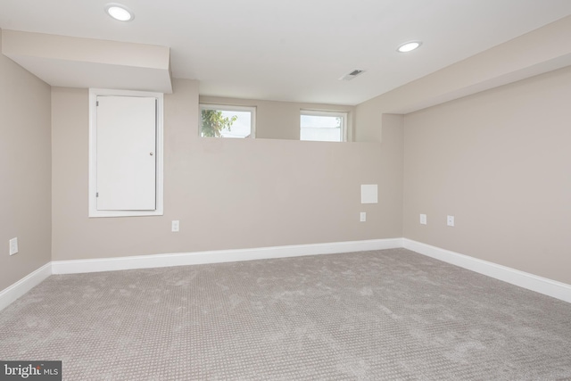 basement with carpet floors, recessed lighting, visible vents, and baseboards