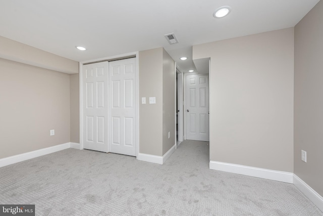 unfurnished bedroom featuring carpet floors, baseboards, visible vents, and recessed lighting