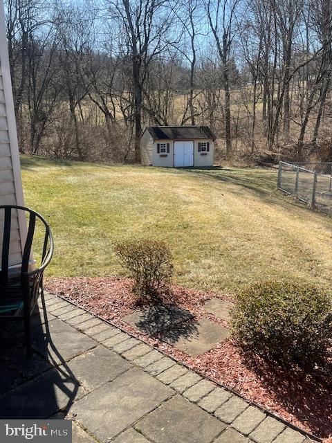 view of yard with an outdoor structure and fence