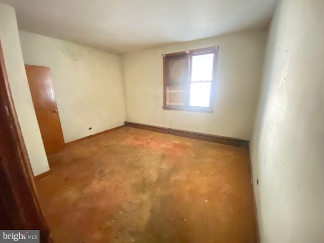 spare room featuring baseboards