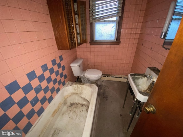 bathroom featuring baseboard heating, toilet, and tile walls