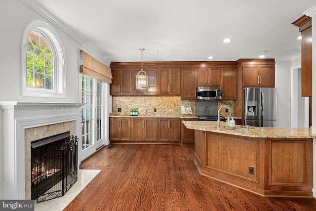 4637 Kirkland Pl, Alexandria, VA 22311 - kitchen with stainless steel appliances, brown cabinetry, dark wood-style flooring, tasteful backsplash, and light stone counters