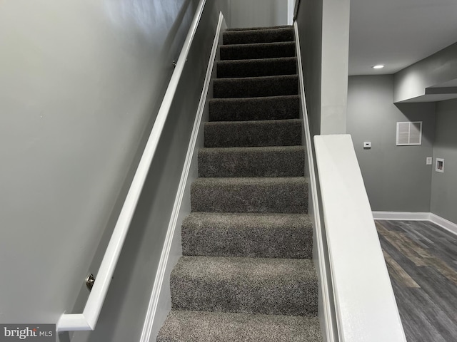 stairs featuring baseboards and wood finished floors