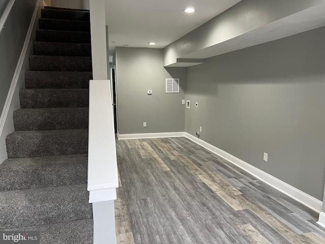 basement with stairs, recessed lighting, baseboards, and wood finished floors