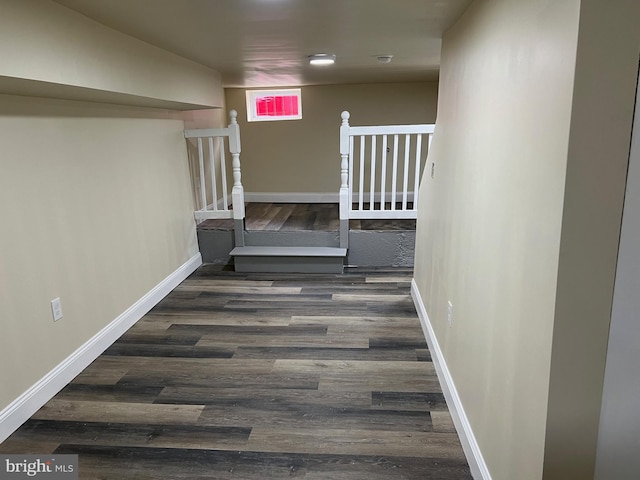 hallway with baseboards and wood finished floors