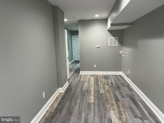 laundry room with visible vents, dark wood finished floors, and baseboards