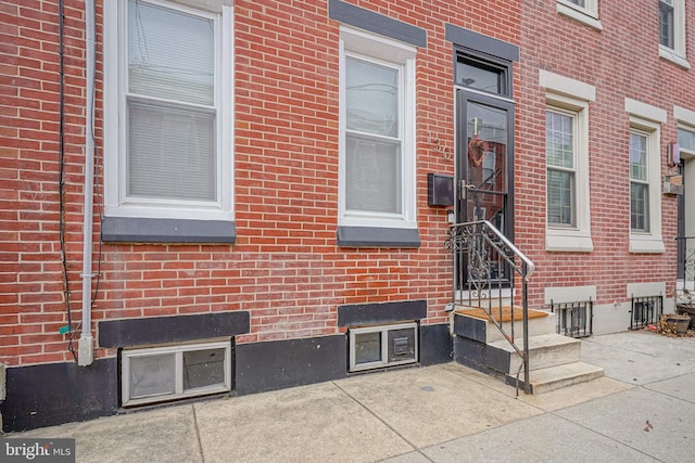 property entrance with brick siding