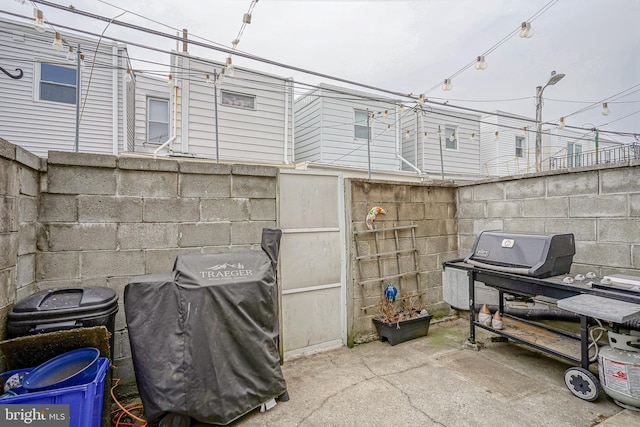 view of patio featuring fence and grilling area