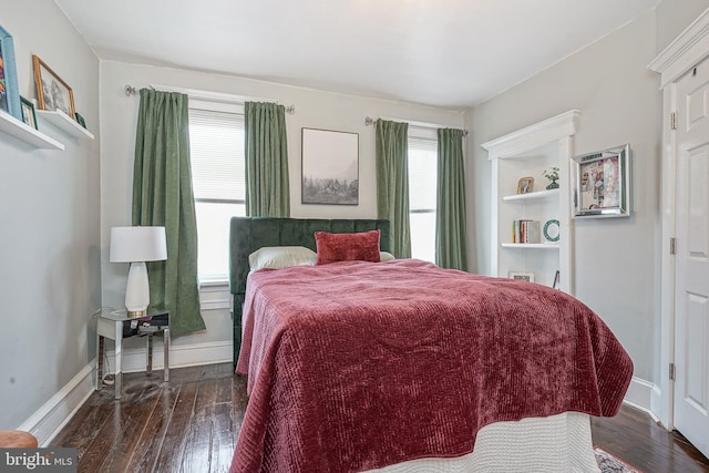 bedroom featuring baseboards and hardwood / wood-style floors