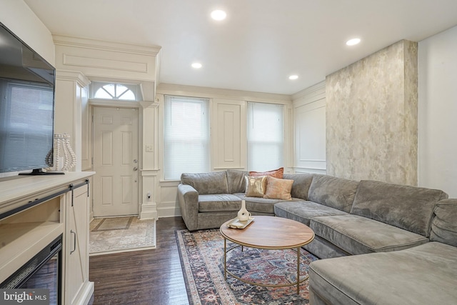 living area with recessed lighting and dark wood-style flooring