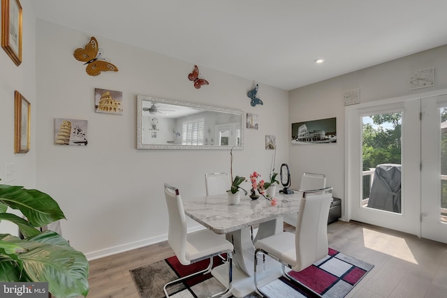 dining space featuring recessed lighting, baseboards, and light wood finished floors