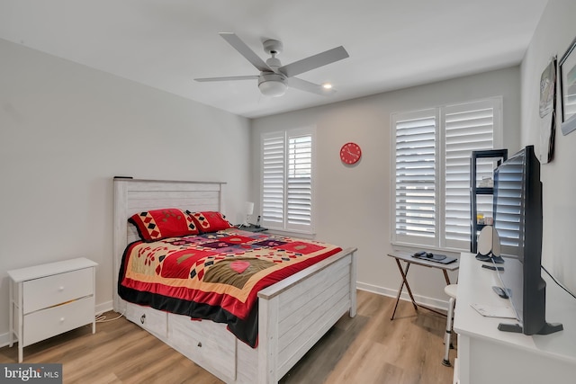 bedroom with light wood-type flooring, baseboards, and a ceiling fan