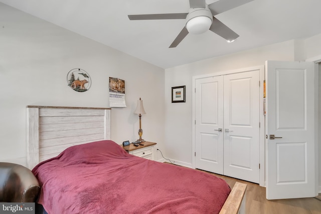 bedroom with ceiling fan, a closet, and wood finished floors