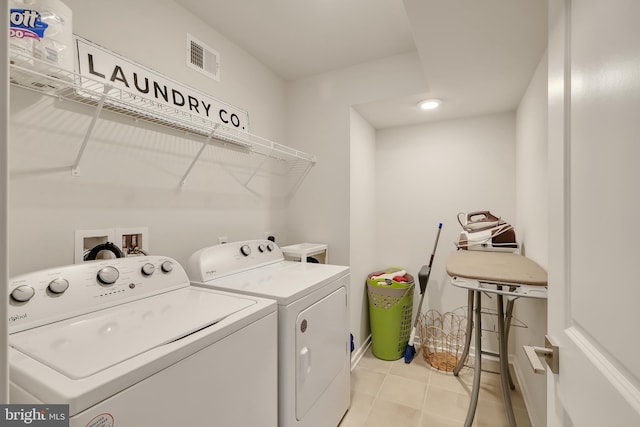 laundry area with laundry area, light tile patterned floors, visible vents, and separate washer and dryer