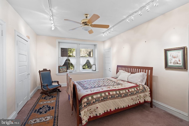 bedroom with carpet, baseboards, and track lighting