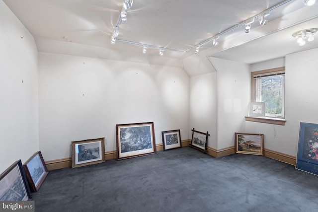 additional living space featuring carpet floors and baseboards