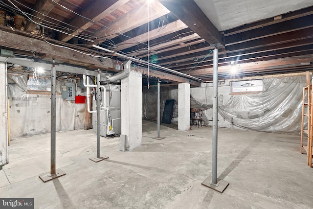 unfinished basement with electric panel and heating unit