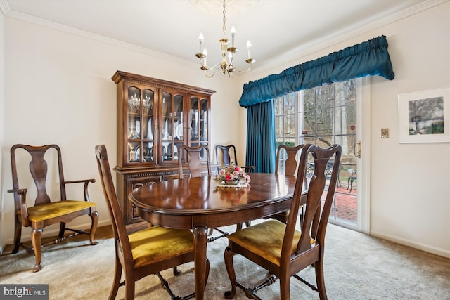 dining area featuring a notable chandelier, light colored carpet, crown molding, and baseboards