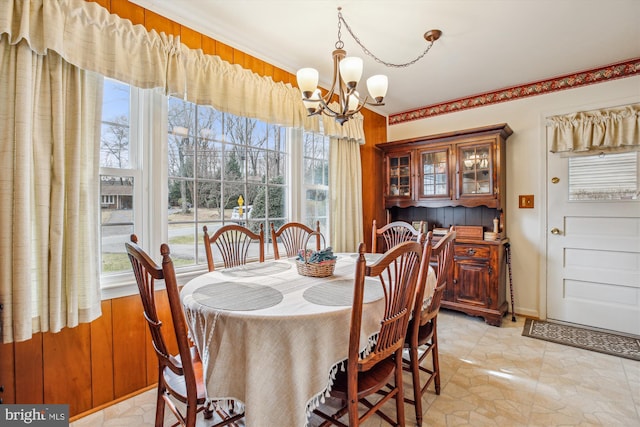 dining area with an inviting chandelier