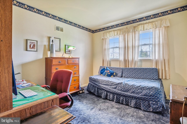 carpeted bedroom featuring visible vents, wallpapered walls, and baseboards