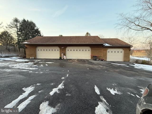 view of front facade featuring fence and a garage