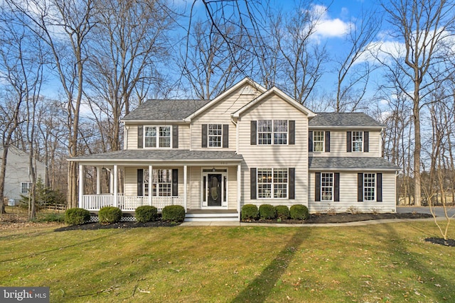 view of front of property featuring a porch, roof with shingles, and a front lawn