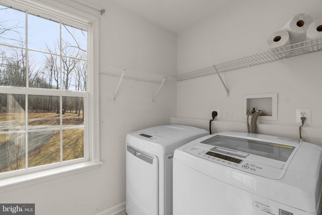 washroom with laundry area, separate washer and dryer, and a wealth of natural light