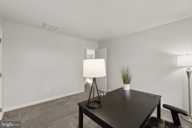 carpeted office featuring visible vents and baseboards