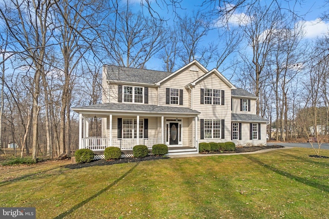 view of front of home with a porch, roof with shingles, and a front lawn