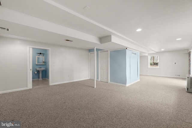 below grade area featuring carpet, visible vents, baseboards, and recessed lighting