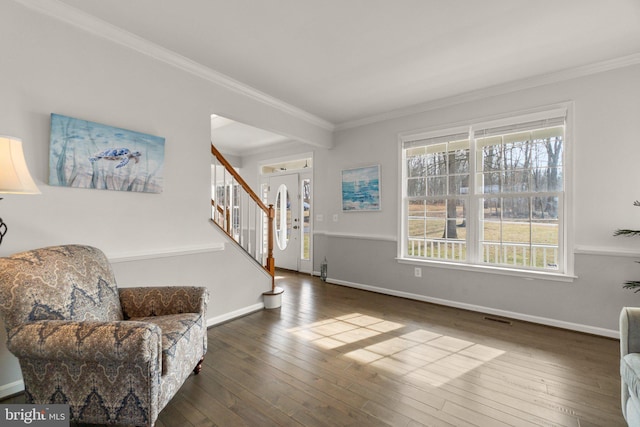 living area featuring stairs, visible vents, hardwood / wood-style flooring, and crown molding