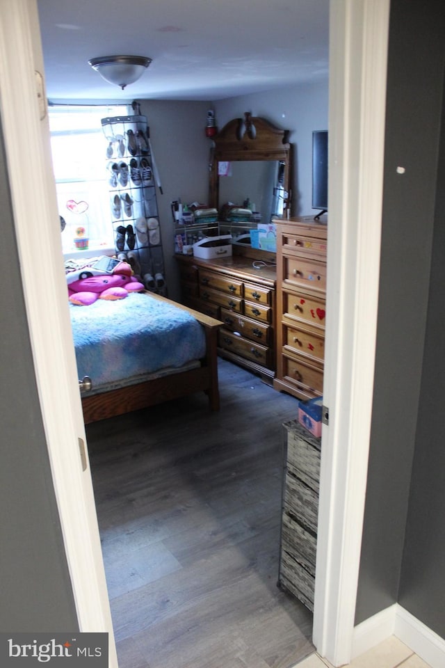 bedroom featuring wood finished floors and baseboards