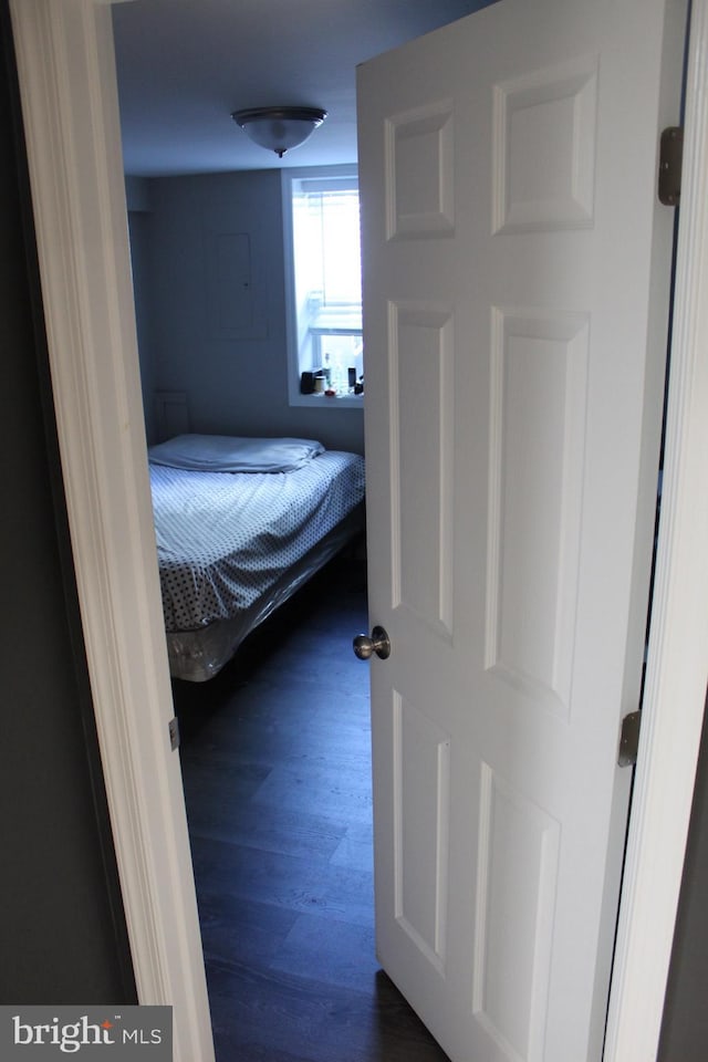 unfurnished bedroom with dark wood-type flooring