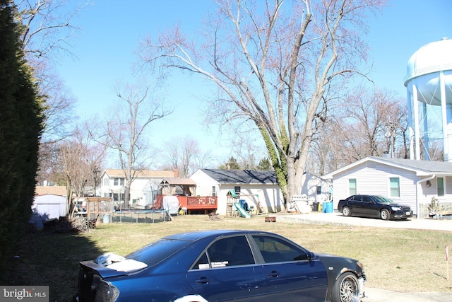 view of front of home featuring a front lawn, a playground, and a residential view