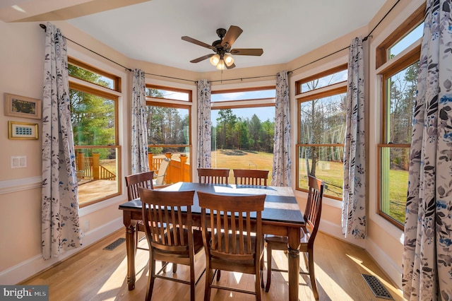 sunroom / solarium featuring visible vents and a ceiling fan