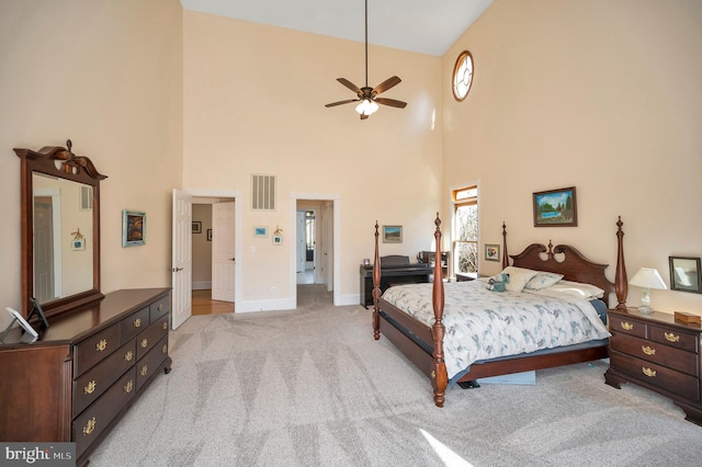 bedroom with light carpet, visible vents, and baseboards