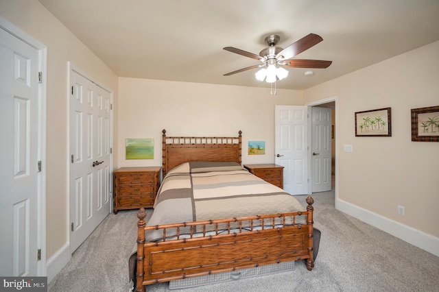 carpeted bedroom with baseboards and a ceiling fan