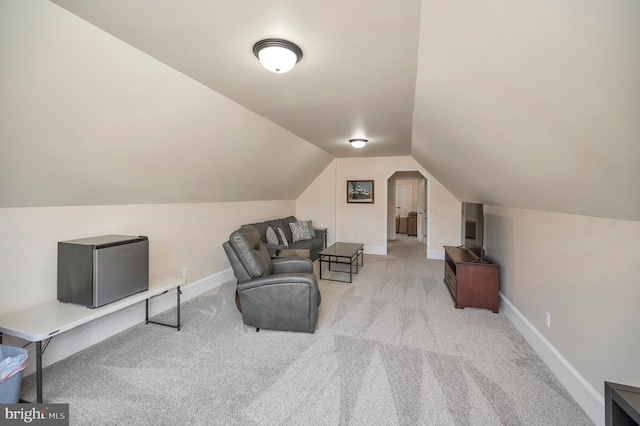 interior space with lofted ceiling, carpet floors, and baseboards