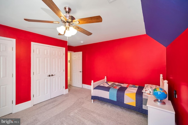 unfurnished bedroom with baseboards, ceiling fan, vaulted ceiling, carpet flooring, and a closet