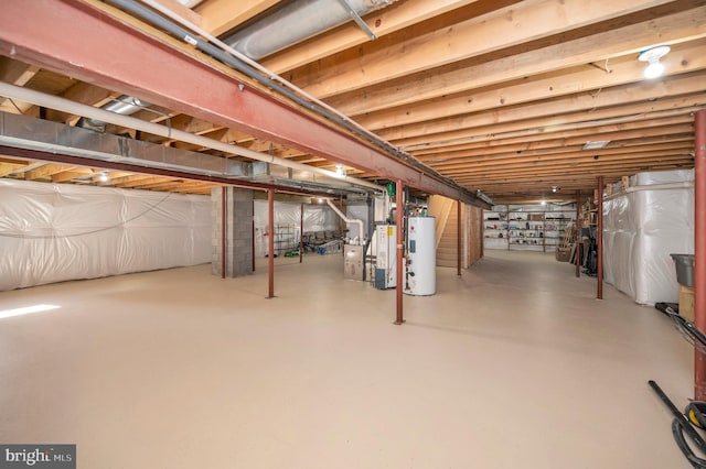 unfinished below grade area with stairs, water heater, and gas water heater