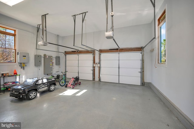 garage with baseboards, electric panel, and a garage door opener