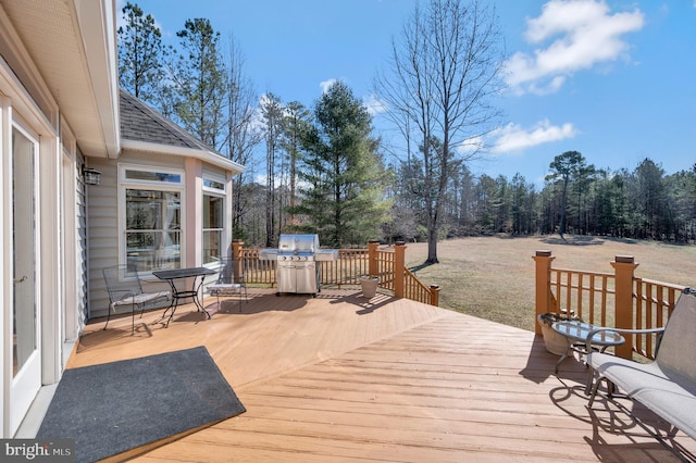 wooden terrace with a grill