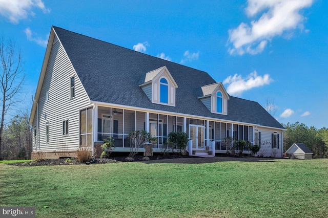 cape cod home with a front lawn, a shingled roof, and a sunroom